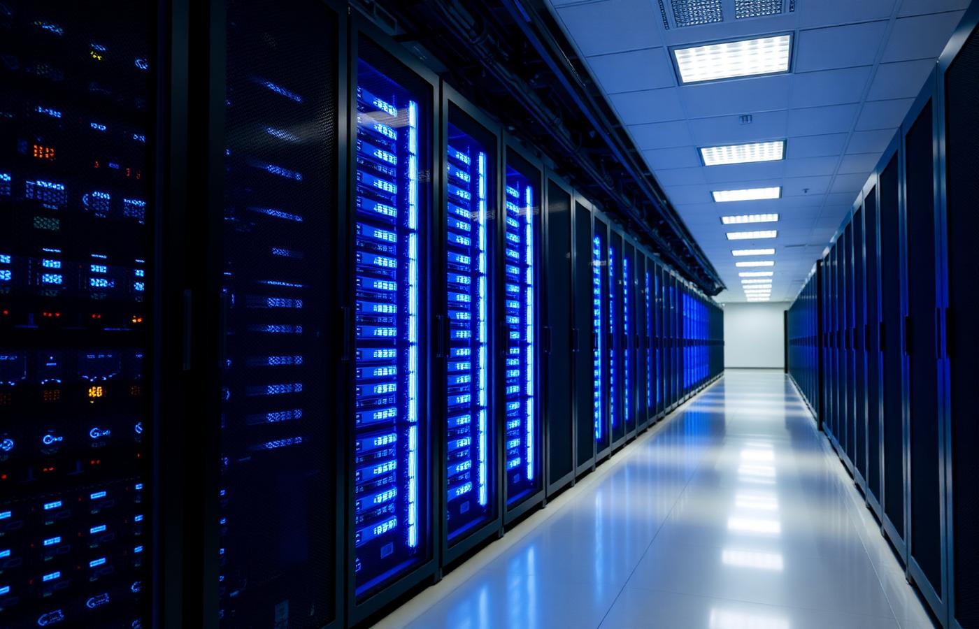 Server room with rows of illuminated server racks